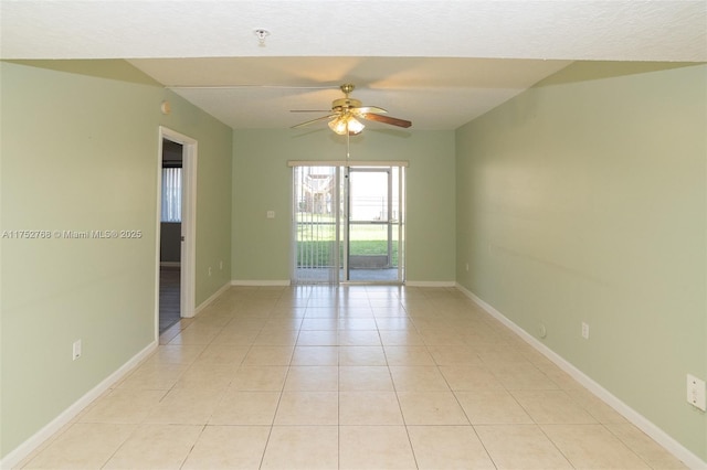 unfurnished room featuring light tile patterned floors, ceiling fan, and baseboards