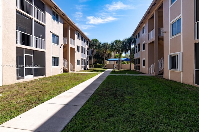 view of property's community featuring a residential view and a lawn