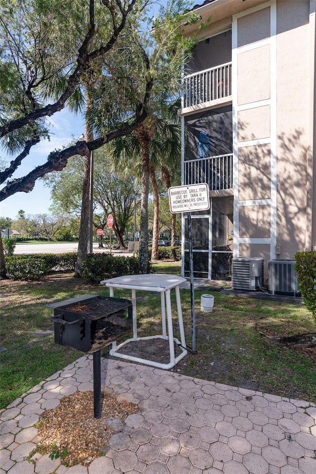 details featuring stucco siding and central air condition unit