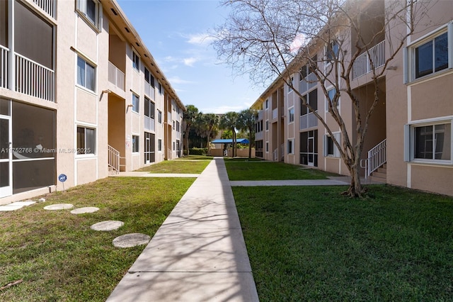 view of property's community featuring a yard