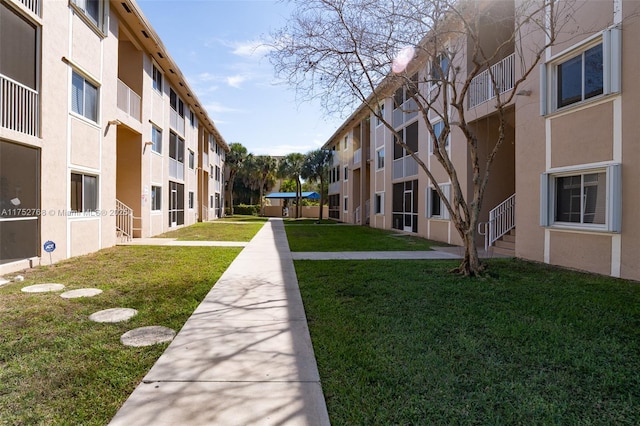 view of home's community with a yard