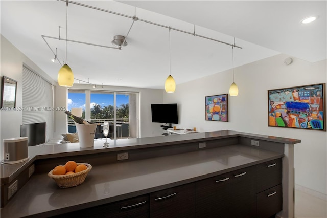 kitchen featuring open floor plan, hanging light fixtures, dark countertops, and recessed lighting