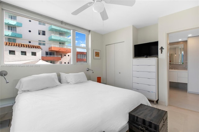 bedroom featuring a closet, ceiling fan, and ensuite bathroom