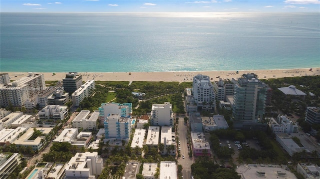 drone / aerial view featuring a view of the beach, a view of city, and a water view