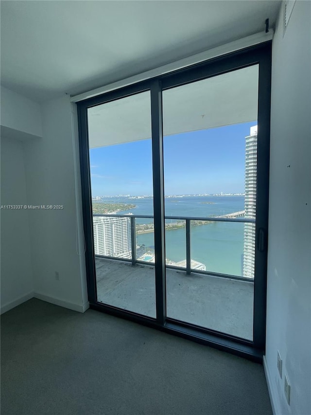 empty room featuring baseboards and a water view