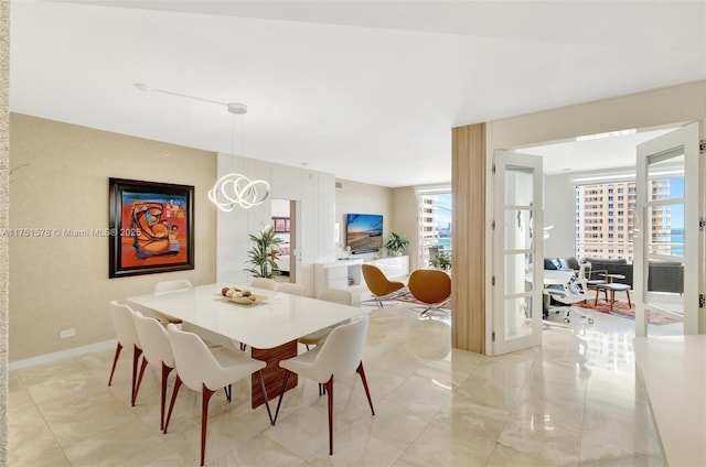 dining room with marble finish floor and baseboards