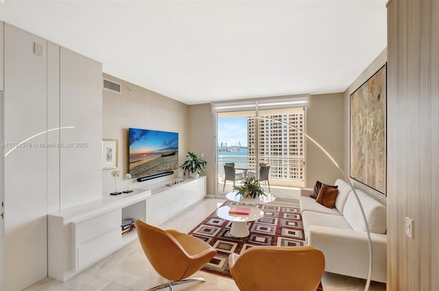 living room featuring visible vents and floor to ceiling windows