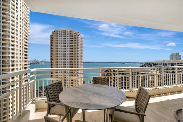 balcony featuring a water view and a view of city