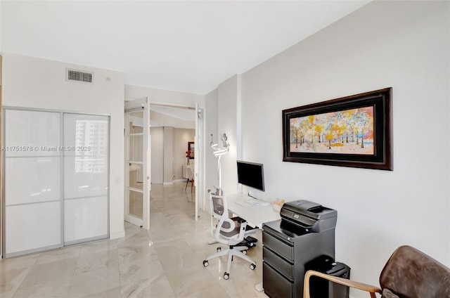 office with marble finish floor and visible vents