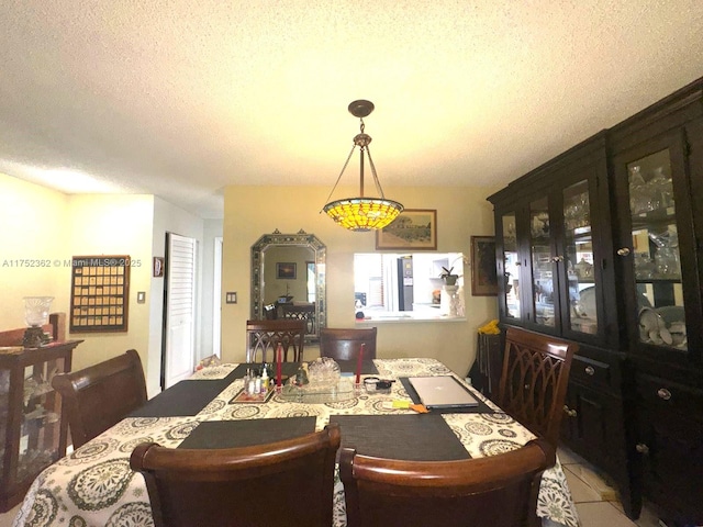 dining space featuring a textured ceiling