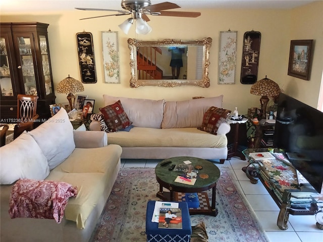 tiled living area with a ceiling fan