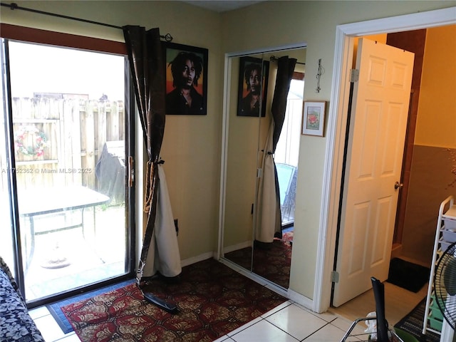 doorway with baseboards and a wealth of natural light