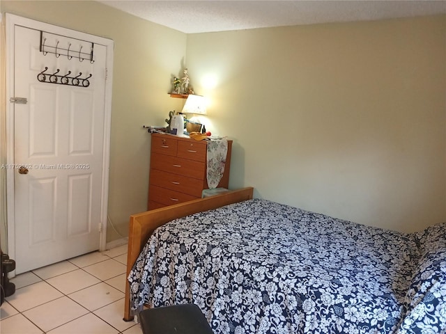 bedroom featuring a textured ceiling and light tile patterned flooring