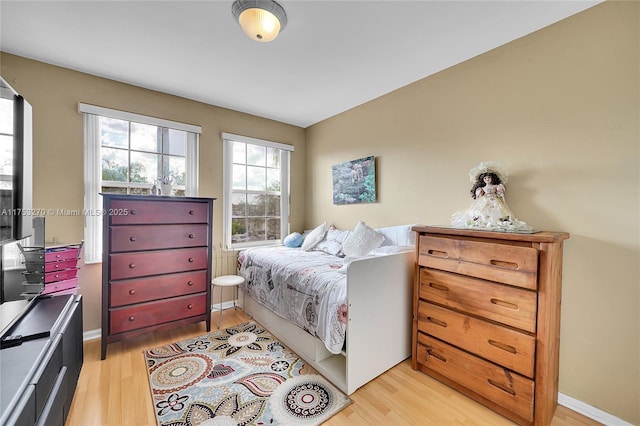 bedroom featuring light wood-type flooring and baseboards