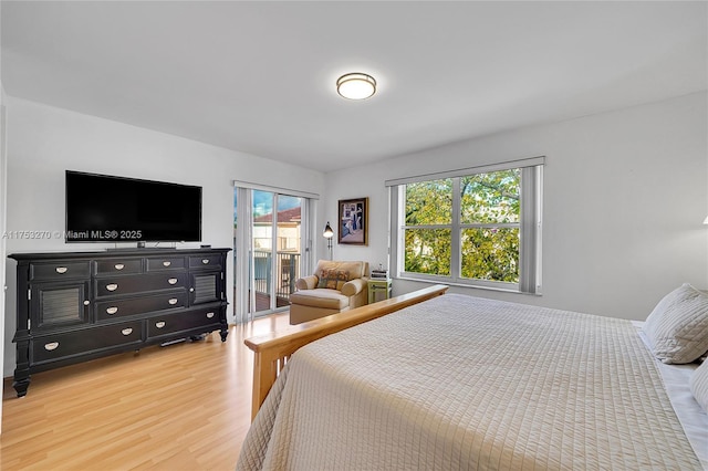 bedroom featuring light wood-style floors and access to exterior