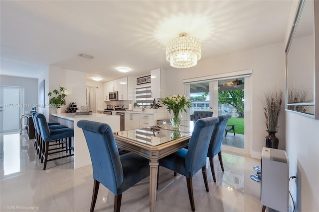 dining space with an inviting chandelier and light tile patterned flooring