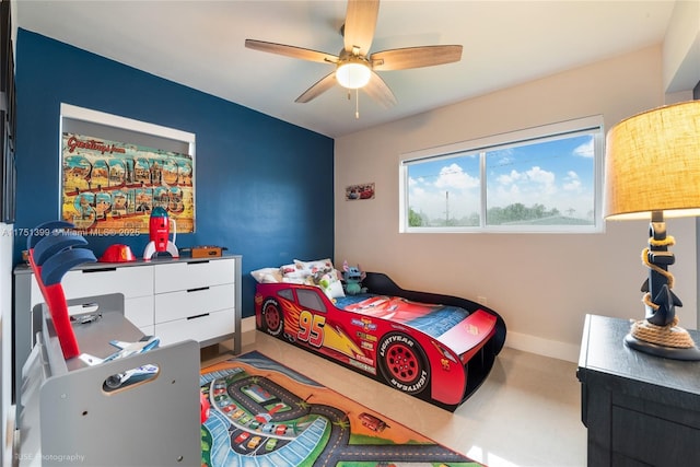 bedroom with ceiling fan and baseboards