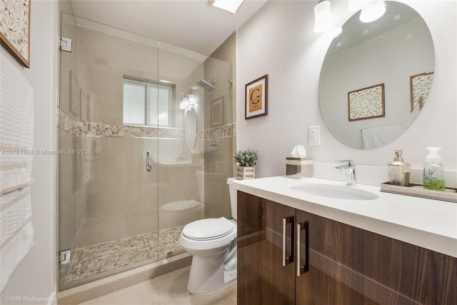 bathroom with a stall shower, tile patterned flooring, vanity, and toilet