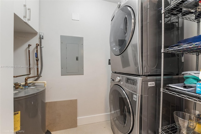 laundry area featuring gas water heater, laundry area, electric panel, tile patterned floors, and stacked washer and clothes dryer