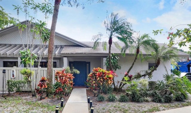 view of front of home with fence and stucco siding