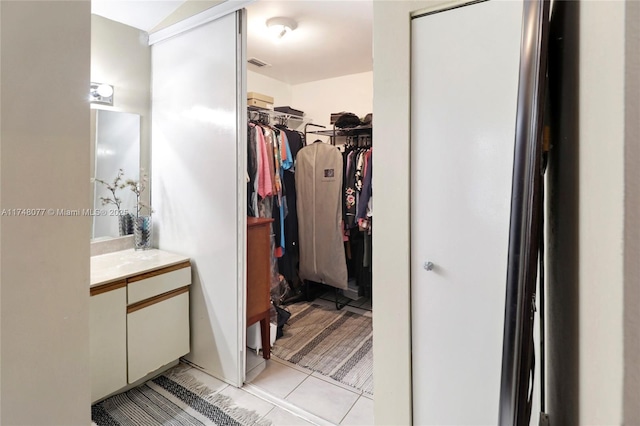 spacious closet featuring visible vents and light tile patterned flooring