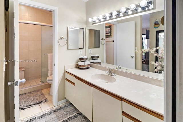 full bath with toilet, tile patterned flooring, vanity, and a shower stall