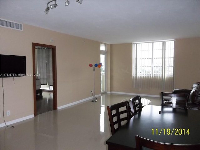 dining space featuring tile patterned flooring, visible vents, and baseboards