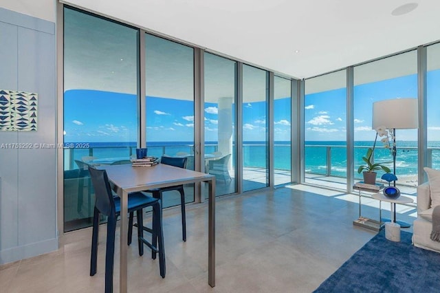 interior space with a water view and floor to ceiling windows