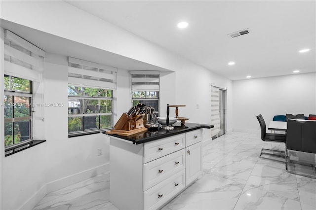 kitchen with dark countertops, recessed lighting, and baseboards