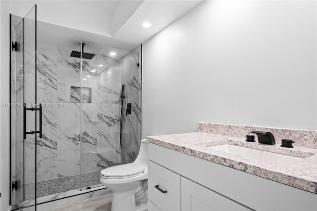 full bath featuring toilet, recessed lighting, a marble finish shower, and vanity