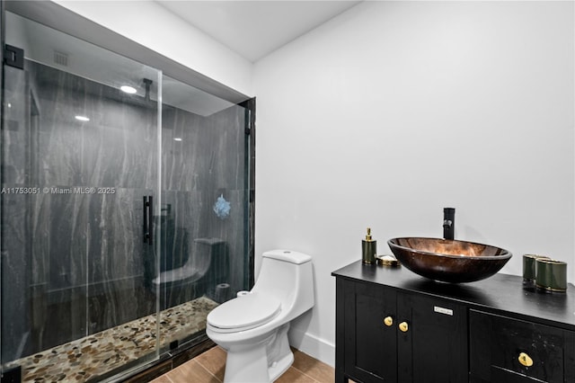 full bath with toilet, a marble finish shower, baseboards, and vanity