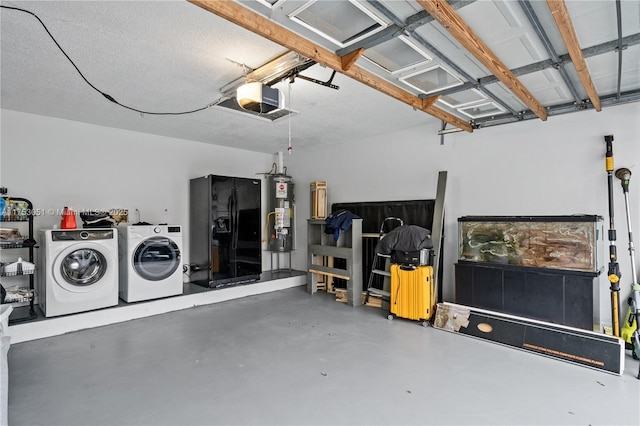 garage featuring a garage door opener, washing machine and dryer, water heater, and black fridge