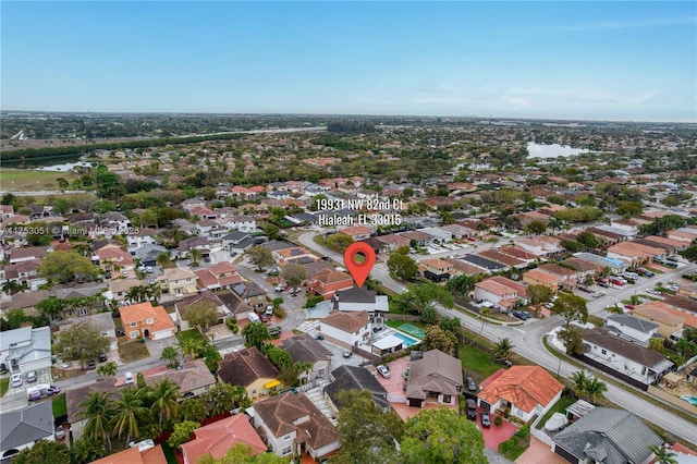 drone / aerial view featuring a residential view and a water view