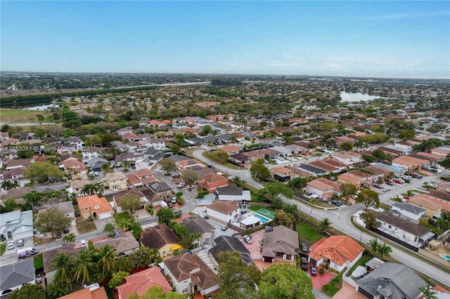 drone / aerial view featuring a water view and a residential view