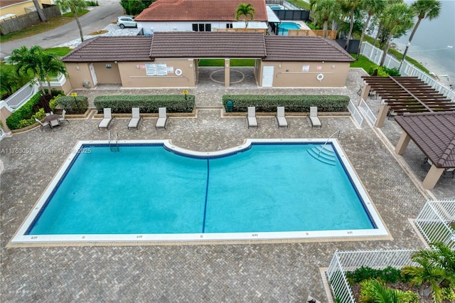 pool with fence and a patio