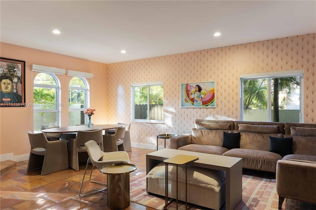 living area featuring recessed lighting, baseboards, and wallpapered walls