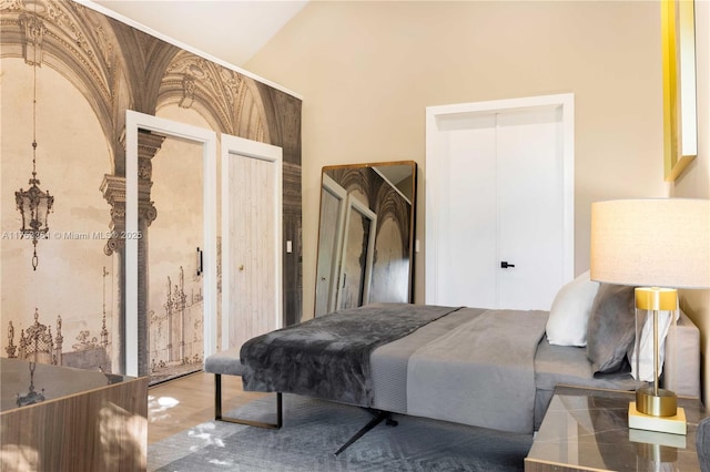 bedroom featuring lofted ceiling and two closets