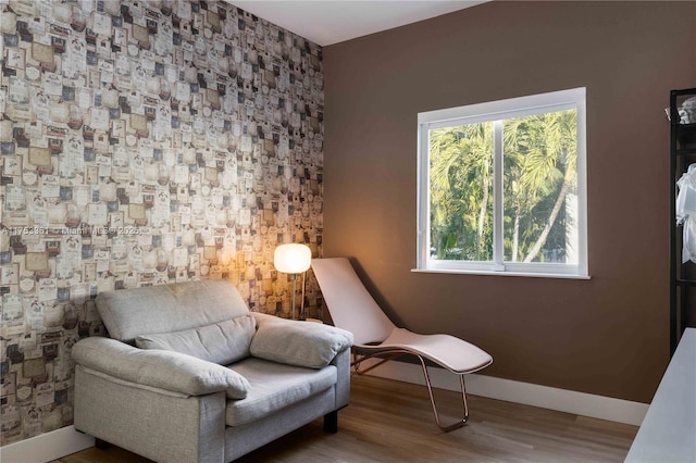 living area featuring baseboards and wood finished floors