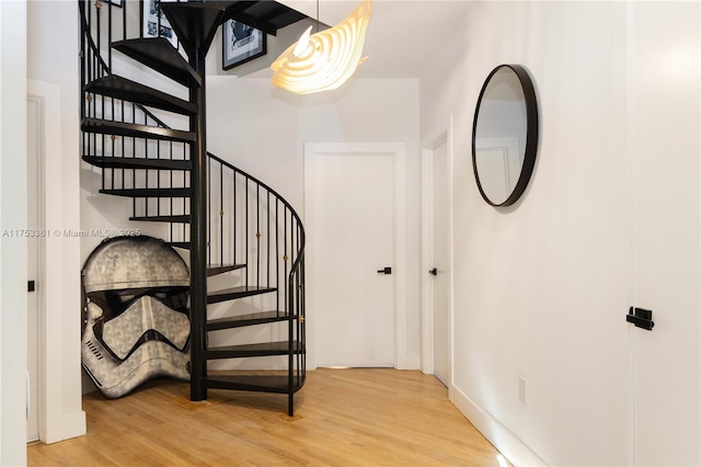 stairs featuring wood finished floors