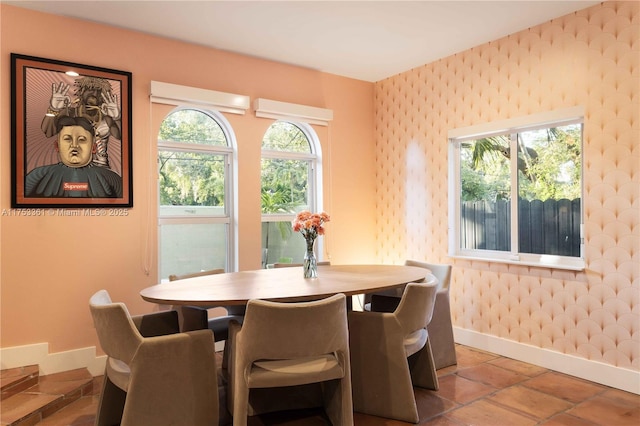 dining room with wallpapered walls and baseboards