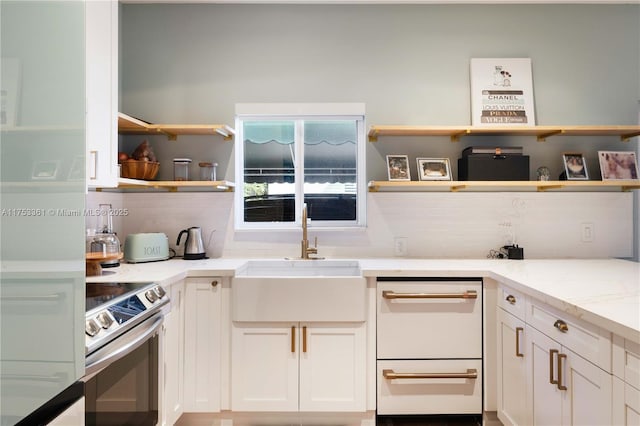 kitchen featuring dishwasher, open shelves, electric range, and a sink