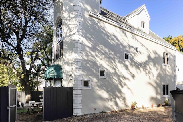 view of side of property featuring fence