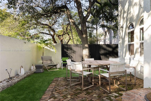 view of patio / terrace with outdoor dining space and a fenced backyard