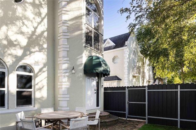 view of patio / terrace featuring outdoor dining area and fence