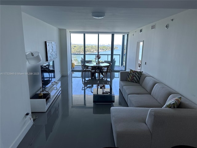 living room with a wall of windows, visible vents, and baseboards