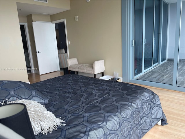 bedroom with wood finished floors and visible vents
