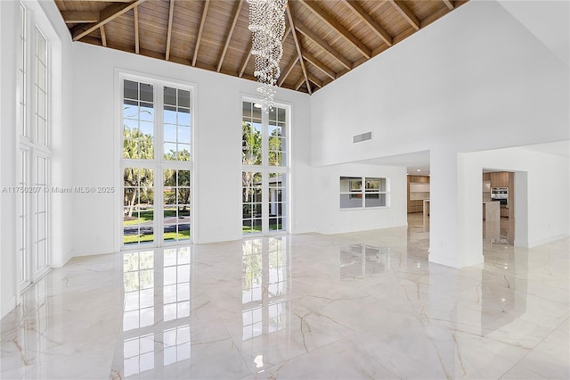 interior space with high vaulted ceiling, visible vents, wood ceiling, marble finish floor, and an inviting chandelier