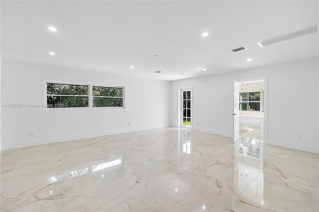 empty room featuring baseboards, marble finish floor, visible vents, and recessed lighting