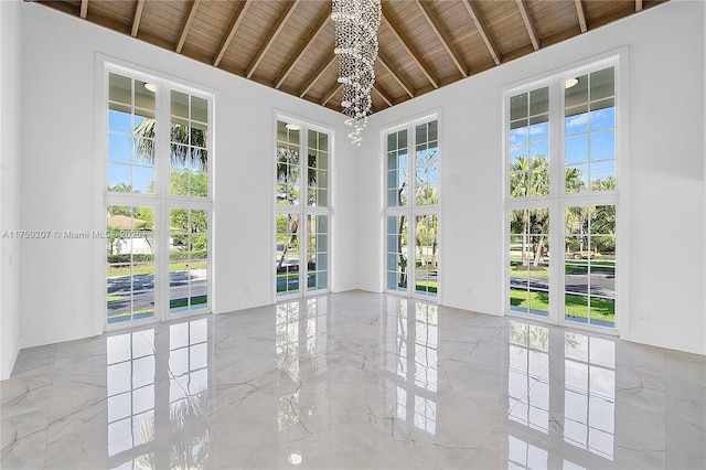 unfurnished sunroom featuring wooden ceiling, plenty of natural light, and lofted ceiling with beams