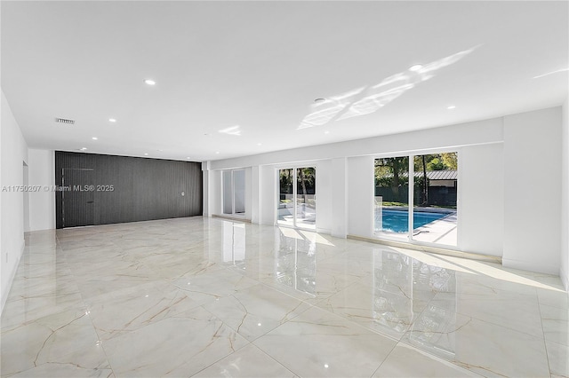 unfurnished room featuring marble finish floor, visible vents, and recessed lighting